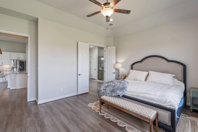 112 Bittik Cv, Georgetown, TX 78628 - bedroom featuring stainless steel fridge, dark wood finished floors, and a ceiling fan