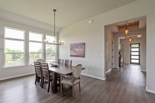 112 Bittik Cv, Georgetown, TX 78628 - dining area featuring dark wood-style flooring, a chandelier, and a tray ceiling