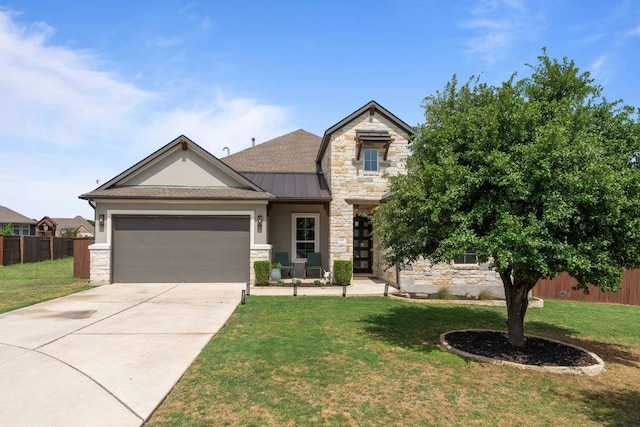 112 Bittik Cv, Georgetown, TX 78628 - view of front of house featuring stone siding, a standing seam roof, and an attached garage