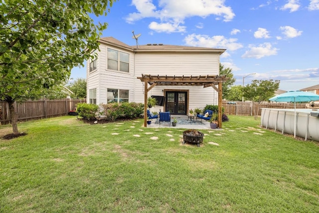 back of property featuring a fire pit, a pergola, a fenced backyard, french doors, and a lawn