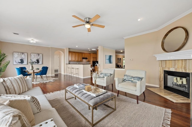 12401 Fairfax Ridge Pl, Austin, TX 78738 - living area with crown molding, wood finished floors, baseboards, ceiling fan, and a tile fireplace