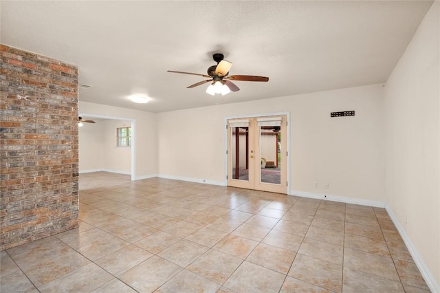 unfurnished room with light tile patterned floors, baseboards, ceiling fan, and french doors