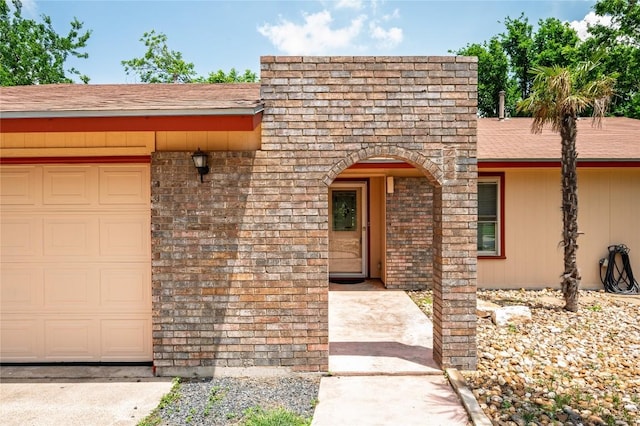 view of front of house featuring a shingled roof and an attached garage