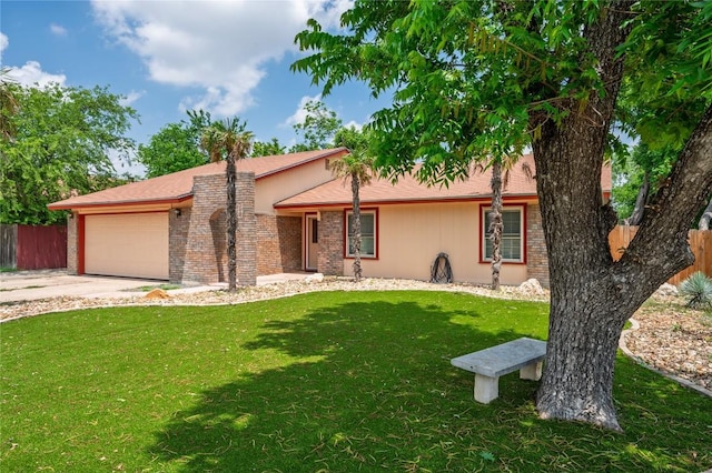 ranch-style home with an attached garage, fence, driveway, and a front yard