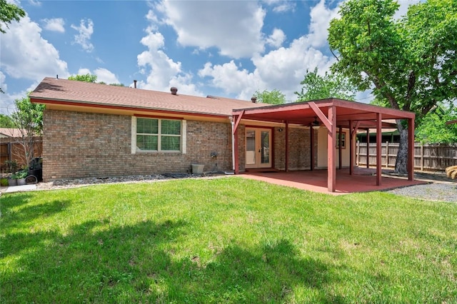 back of house featuring fence, a patio area, french doors, and brick siding
