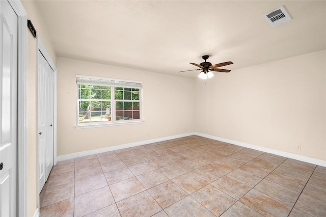 unfurnished bedroom featuring visible vents, baseboards, light tile patterned flooring, and a closet