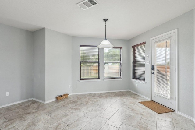 unfurnished dining area with baseboards and visible vents