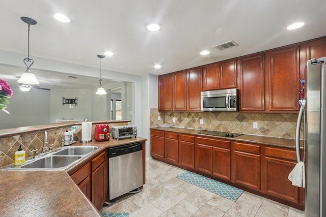 kitchen featuring visible vents, recessed lighting, tasteful backsplash, a sink, and appliances with stainless steel finishes