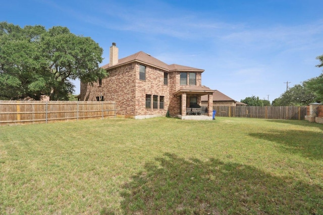 304 Gold Star Dr, Cedar Park, TX 78613 - rear view of house with a chimney, a fenced backyard, and brick siding