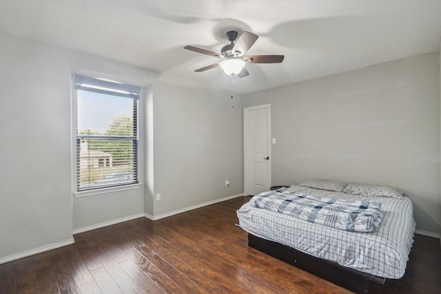 bedroom with baseboards, ceiling fan, and wood finished floors