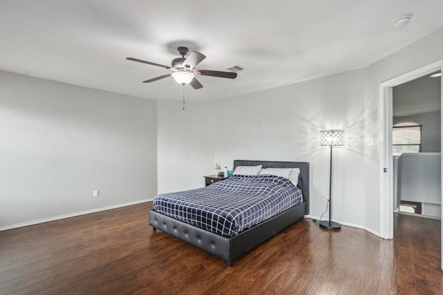 bedroom with ceiling fan, baseboards, visible vents, and wood finished floors