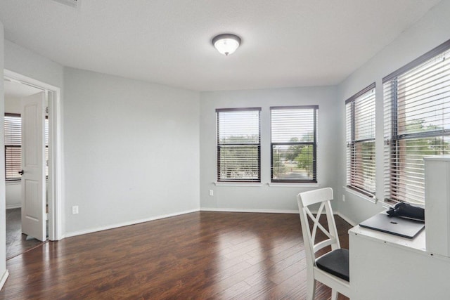 office with baseboards, a wealth of natural light, and wood finished floors