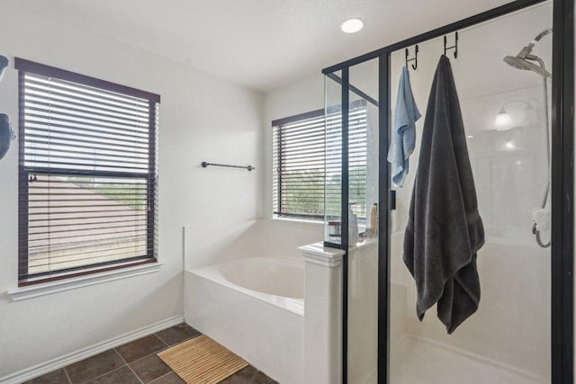 full bath with baseboards, a shower stall, and a bath