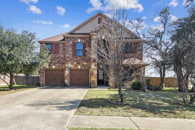traditional-style home with a front lawn, fence, brick siding, an attached garage, and driveway