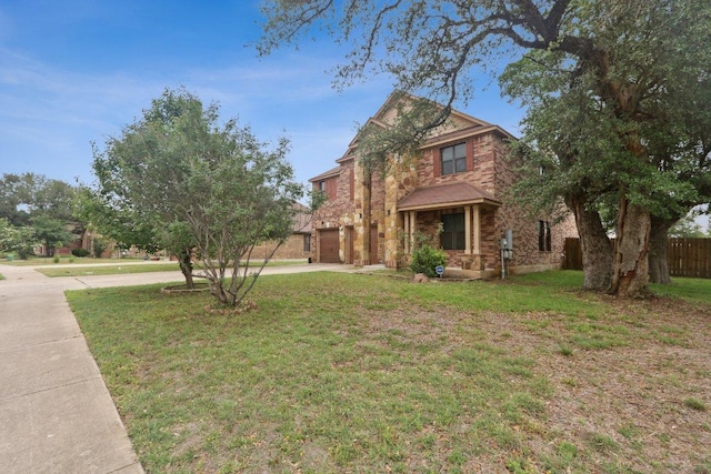 view of front of home featuring a garage, brick siding, fence, a front lawn, and concrete driveway