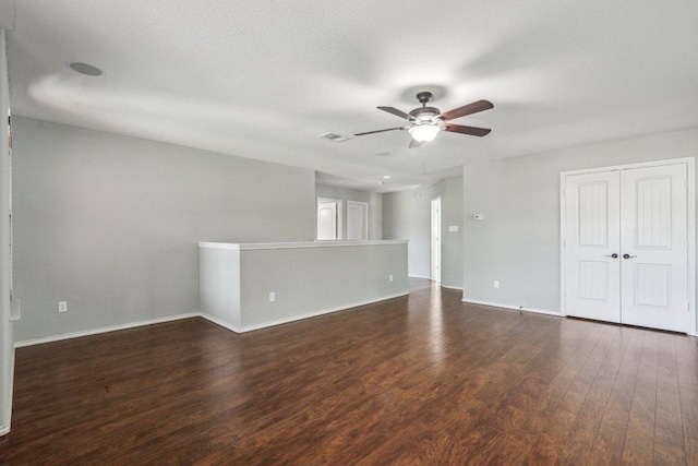 spare room with visible vents, baseboards, ceiling fan, and wood finished floors