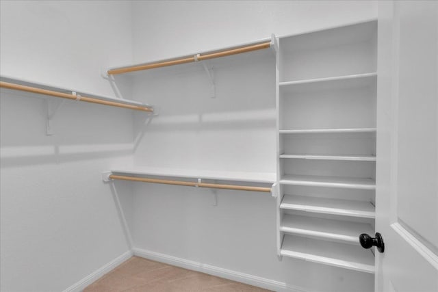 walk in closet with carpet