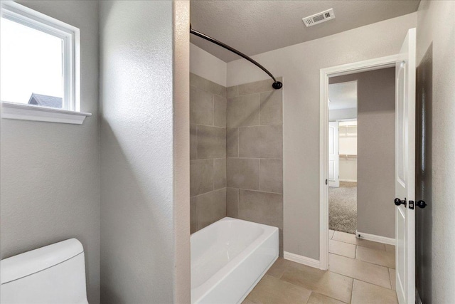 bathroom featuring visible vents, tile patterned flooring, shower / tub combination, baseboards, and toilet
