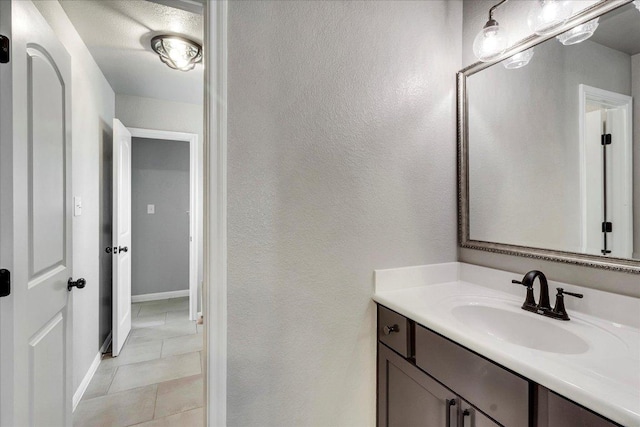 5684 Sabbia Dr, Round Rock, TX 78665 - bathroom with vanity, tile patterned floors, and a textured wall