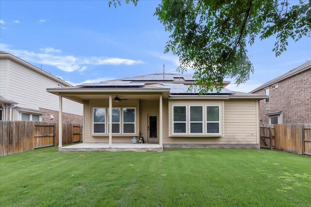 5684 Sabbia Dr, Round Rock, TX 78665 - back of property featuring ceiling fan, a patio area, a fenced backyard, and roof mounted solar panels
