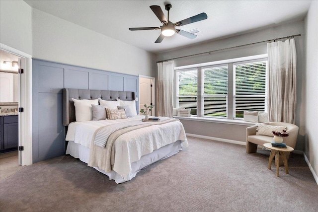 bedroom featuring carpet floors, ceiling fan, ensuite bath, and visible vents