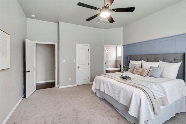 5684 Sabbia Dr, Round Rock, TX 78665 - bedroom with light carpet, ceiling fan, and connected bathroom