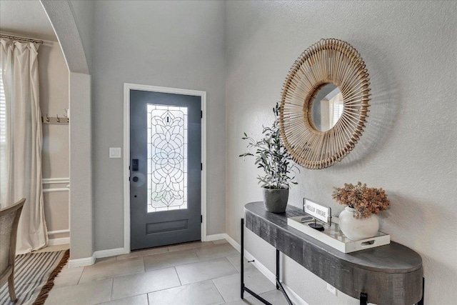 5684 Sabbia Dr, Round Rock, TX 78665 - foyer entrance with light tile patterned floors and baseboards