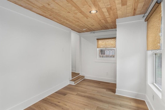 1802 Webberville Rd, Austin, TX 78721 - empty room featuring a healthy amount of sunlight, wood ceiling, baseboards, and light wood finished floors