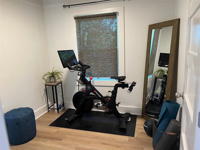 1802 Webberville Rd, Austin, TX 78721 - exercise room with baseboards and wood finished floors