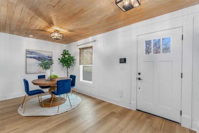 1802 Webberville Rd, Austin, TX 78721 - dining space with baseboards, wooden ceiling, wood finished floors, and a wealth of natural light