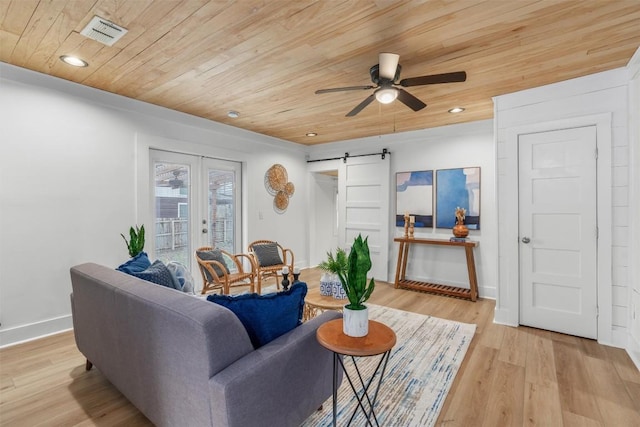 1802 Webberville Rd, Austin, TX 78721 - living room with visible vents, light wood-type flooring, a barn door, wooden ceiling, and a ceiling fan