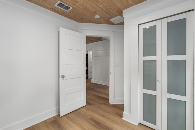 1802 Webberville Rd, Austin, TX 78721 - spare room with baseboards, visible vents, wood ceiling, and light wood finished floors