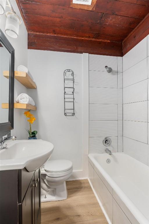 1802 Webberville Rd, Austin, TX 78721 - full bathroom with vanity, wood ceiling, wood finished floors, and toilet