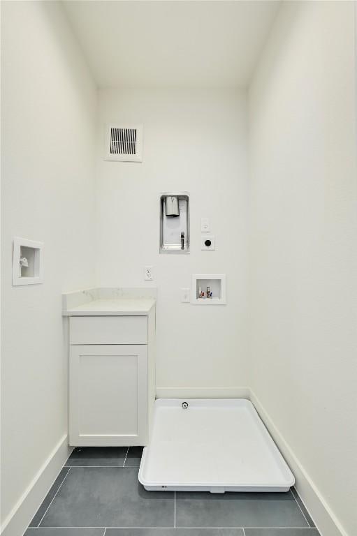 washroom featuring visible vents, baseboards, cabinet space, electric dryer hookup, and washer hookup