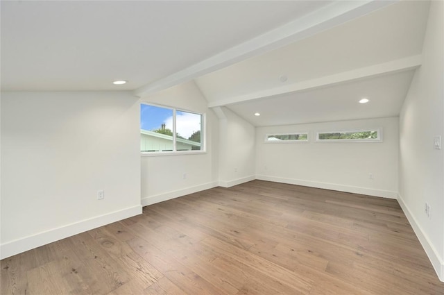 unfurnished room featuring baseboards, lofted ceiling with beams, wood finished floors, and recessed lighting
