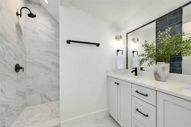 1806 Maple Ave Unit 1, Austin, TX 78702 - full bathroom featuring baseboards, marble finish flooring, a tile shower, and double vanity