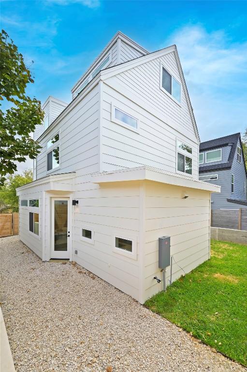 back of house with fence