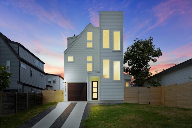 1806 Maple Ave Unit 1, Austin, TX 78702 - back of property at dusk with concrete driveway and a garage