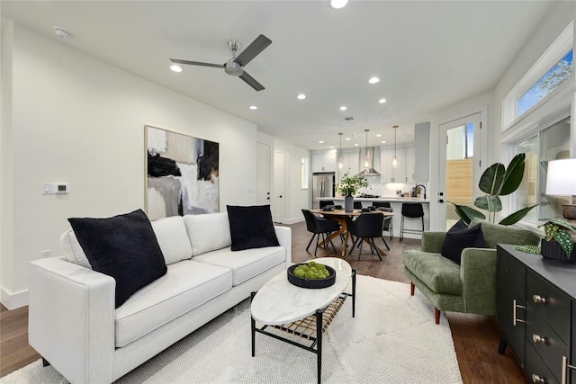 living room featuring recessed lighting, ceiling fan, and wood finished floors