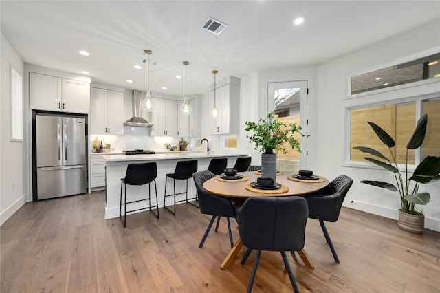 dining area featuring baseboards, recessed lighting, wood finished floors, and visible vents