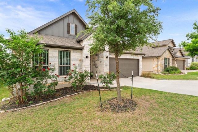view of front of property featuring stone siding, a garage, board and batten siding, a front yard, and concrete driveway