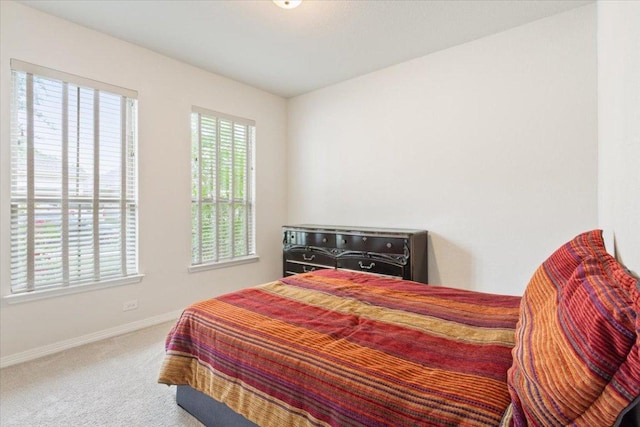 bedroom featuring baseboards and carpet
