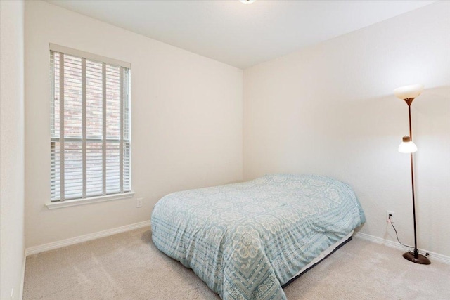bedroom featuring baseboards and carpet