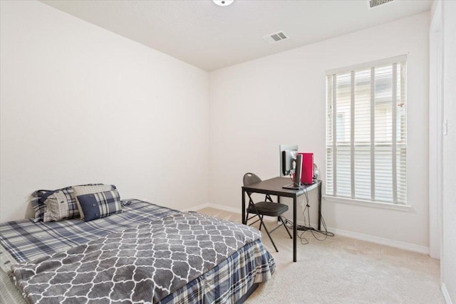 bedroom with baseboards, visible vents, and carpet