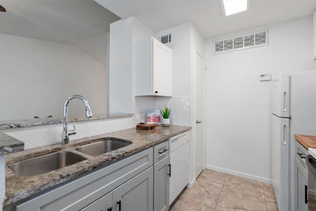 1601 Faro Dr Unit 1102, Austin, TX 78741 - kitchen featuring a sink, white appliances, stone counters, backsplash, and visible vents