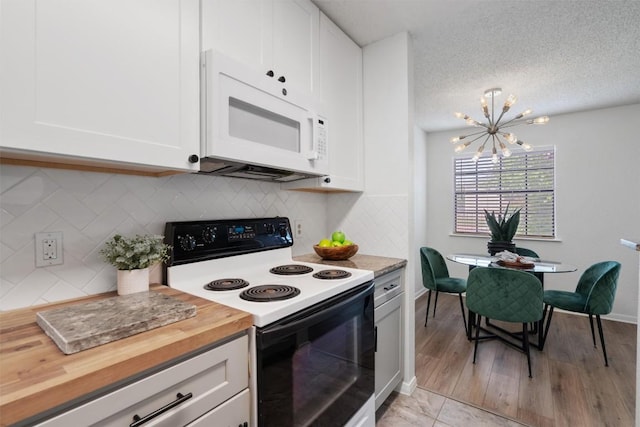 1601 Faro Dr Unit 1102, Austin, TX 78741 - kitchen featuring range with electric cooktop, wooden counters, a chandelier, white cabinetry, and white microwave