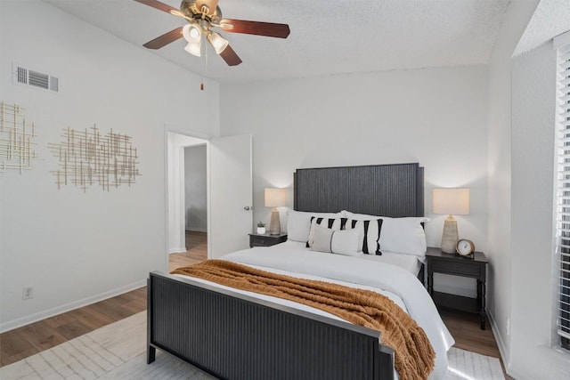 1601 Faro Dr Unit 1102, Austin, TX 78741 - bedroom featuring a ceiling fan, baseboards, wood finished floors, vaulted ceiling, and visible vents