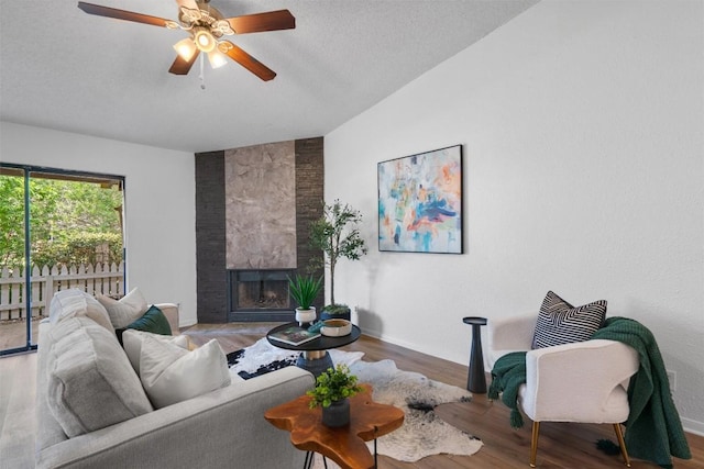 1601 Faro Dr Unit 1102, Austin, TX 78741 - living room with ceiling fan, a fireplace, wood finished floors, baseboards, and lofted ceiling