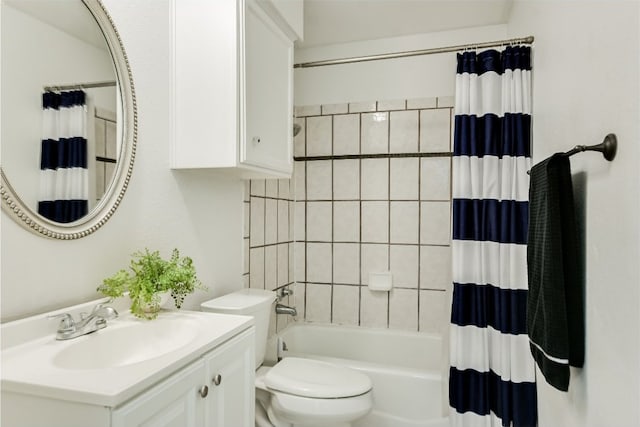 full bathroom featuring shower / bath combination with curtain, toilet, and vanity