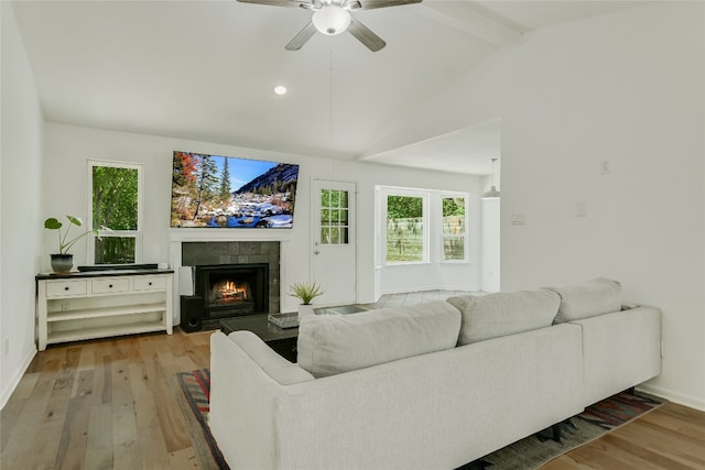 living area featuring wood finished floors, a tiled fireplace, a ceiling fan, plenty of natural light, and recessed lighting